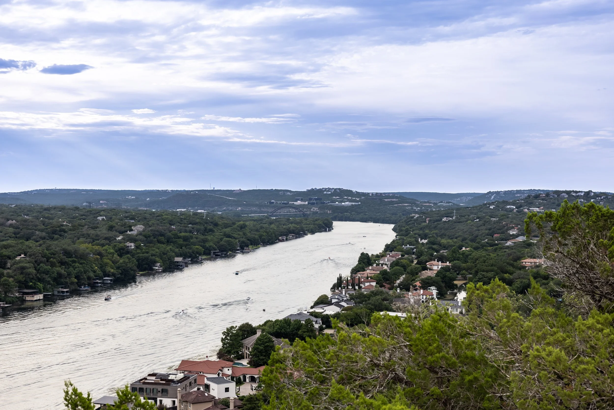 A scenic river view through a green landscape